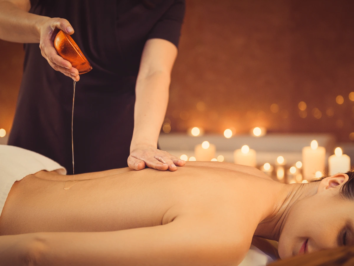 Erotic massage with oil and candles