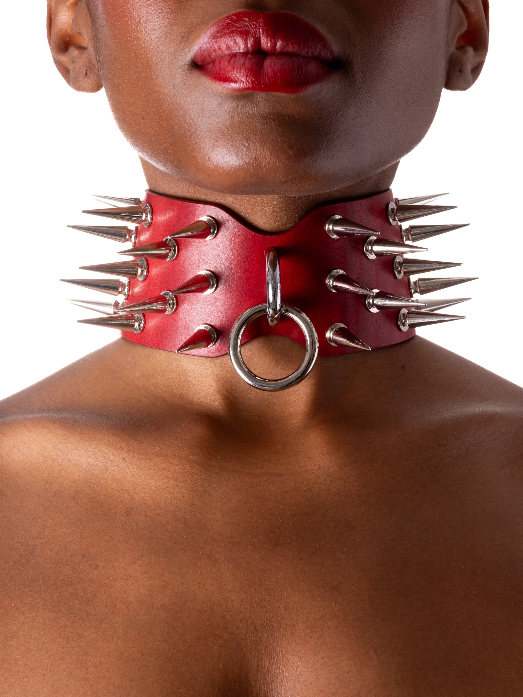 model wearing a red gothic choker with spikes and an oring