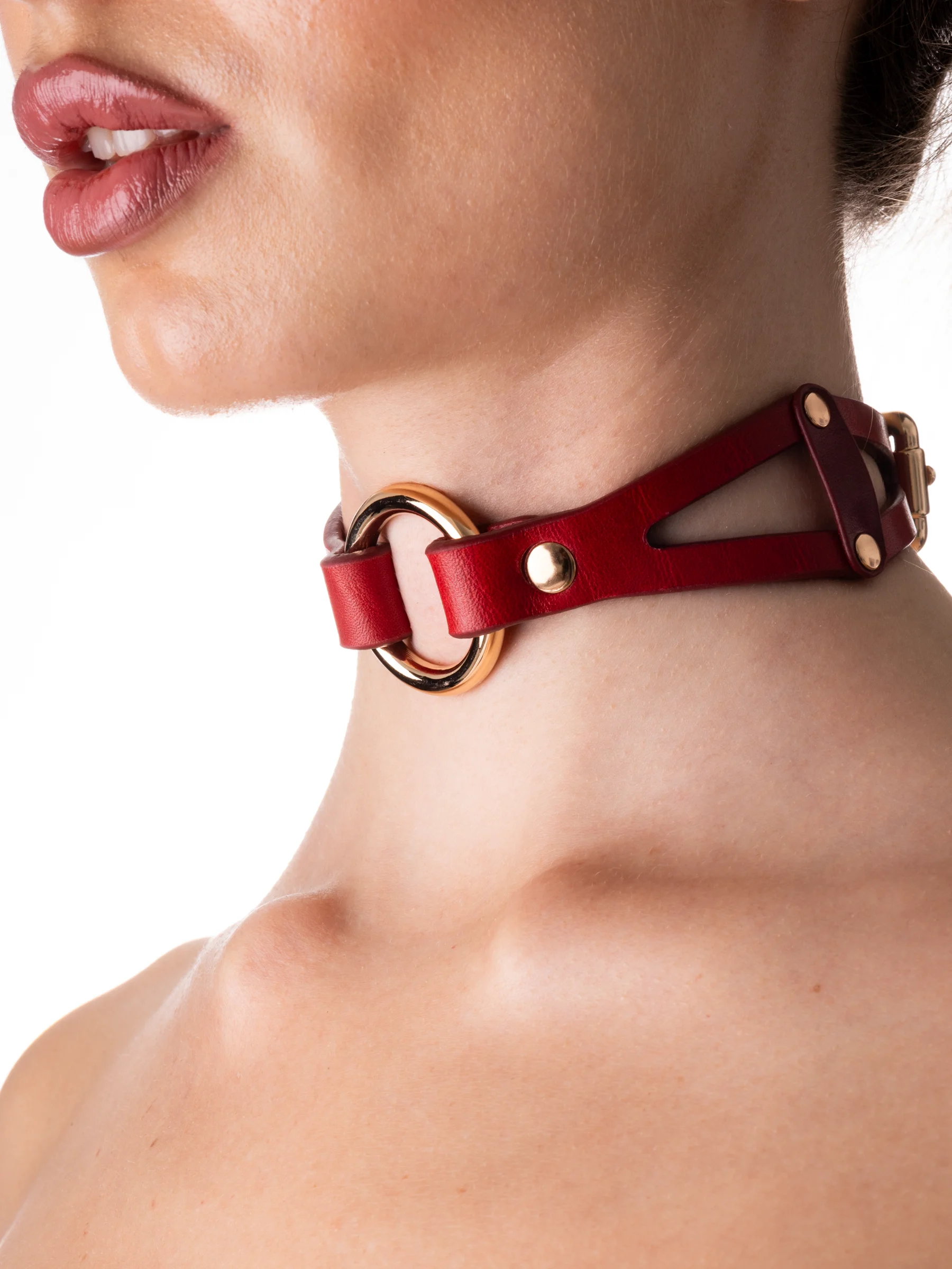 Woman wearing a beautiful red gothic choker with gold metal
